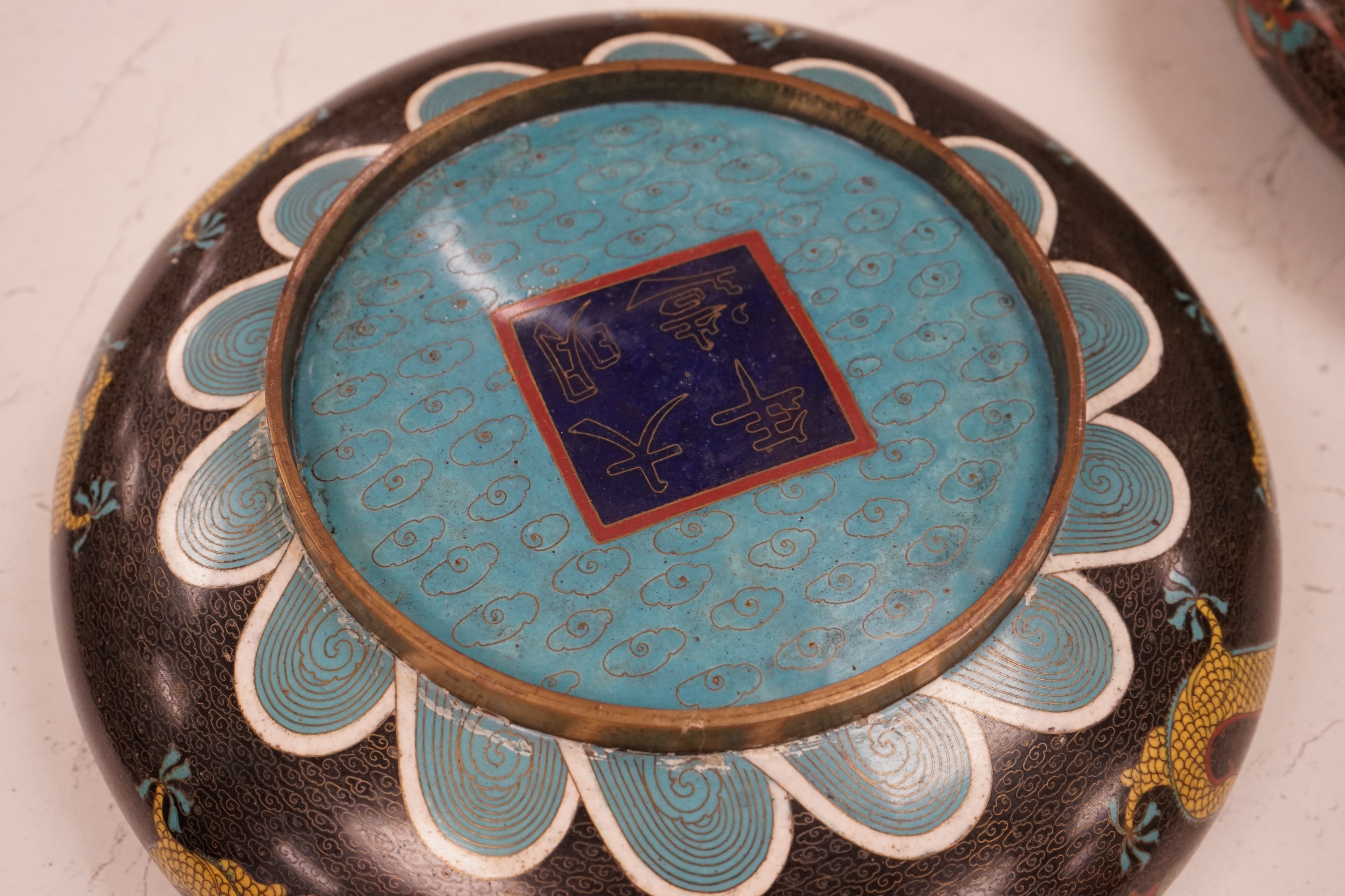 A pair of early 20th century Chinese cloisonné enamel ‘dragon’ bowls, 30cm diameter. Condition - fair to good